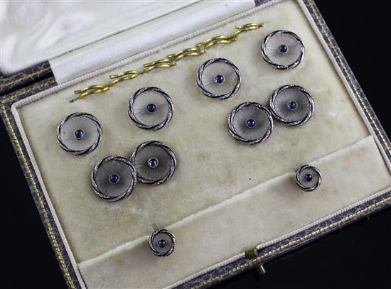 A 1920s cased 18ct gold, frosted glass and blue cabochon set eight piece dress stud set,